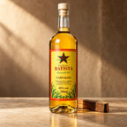 Cachaça de barril Batista Carvalho ao lado de um pedaço de madeira, com luz de fim de tarde